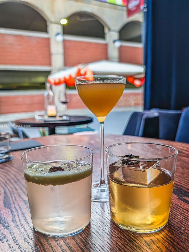 Creative craft cocktails served over clear ice at Bar Ocelli in the ByWard Market.
