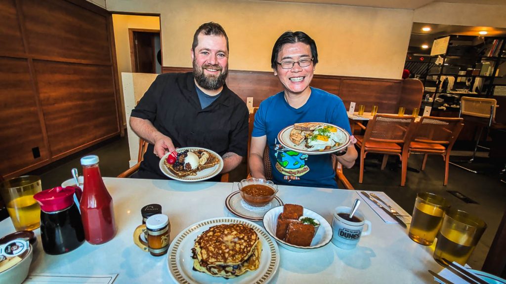 Holding plates of delicious breakfast food at Dukes, a fantastic Ottawa restaurant.