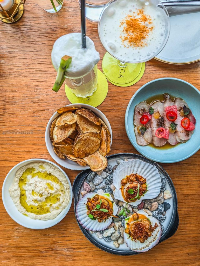 A flatlay of delicious appetizers and craft cocktails showcasing what to eat at Norca Ottawa.