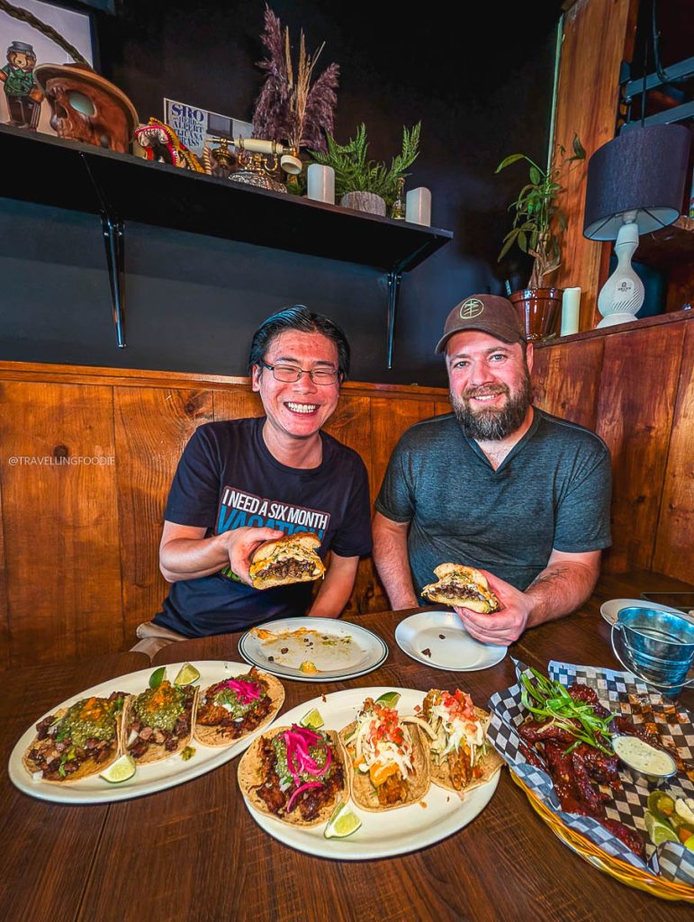 Travelling Foodie Raymond Cua and Chef Justin Champagne-Lagarde holding a carne asada torta at Torta Boyz Ottawa.