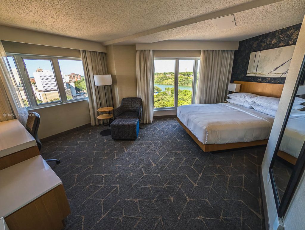 Spacious guest room with a river view at Delta Hotels Saskatoon Downtown, a perfect base to explore Saskatoon food.
