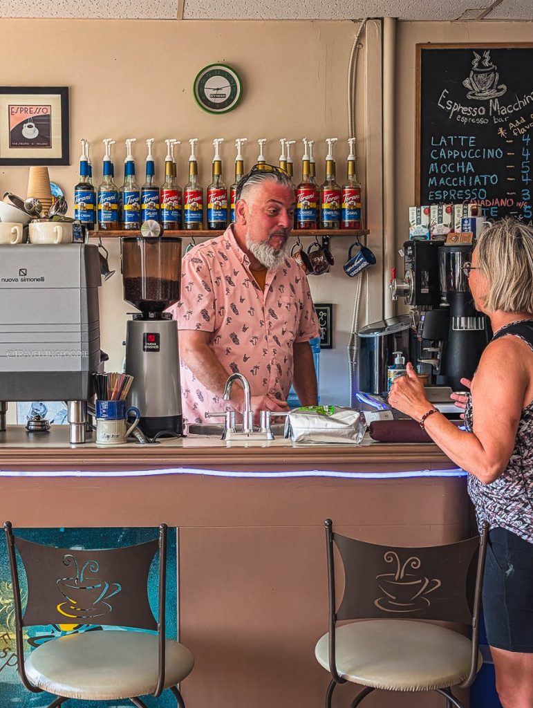 Owner Randall chatting with a customer at Espresso Macchina, a local favorite for Saskatoon coffee shops.