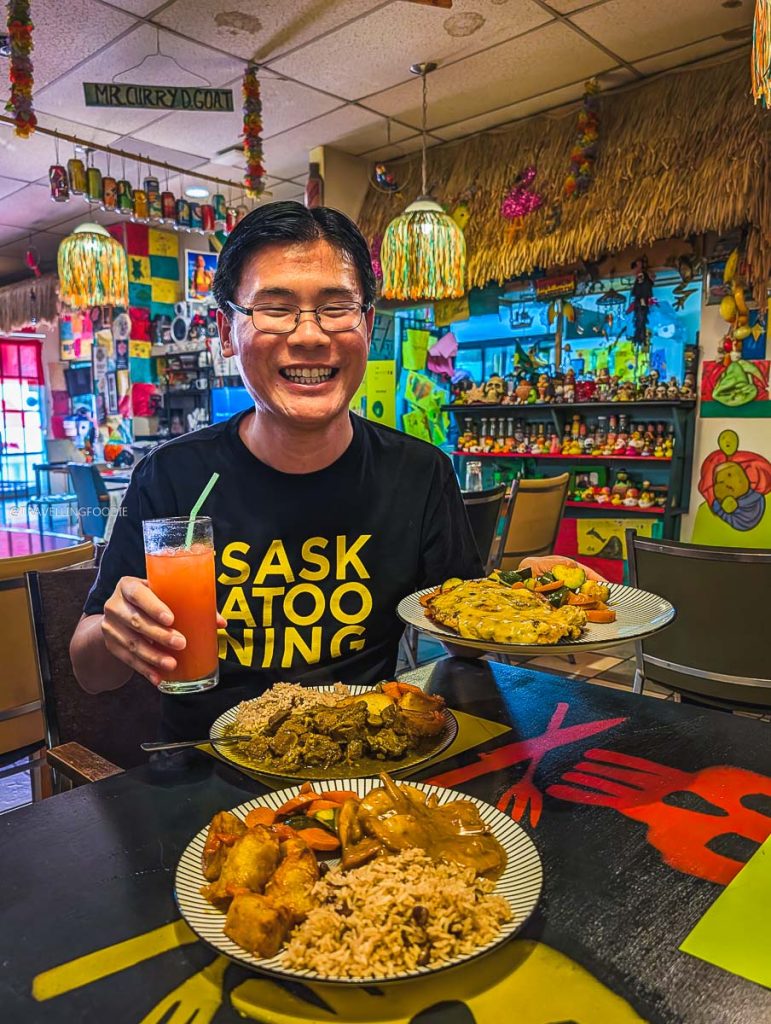 Travelling Foodie Raymond Cua enjoying Curry Goat and Caribbean dishes at Konga Cafe, a top local restaurant in Saskatoon.