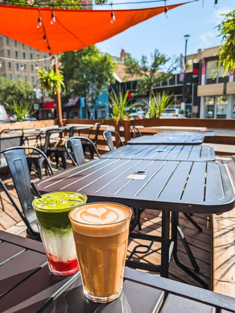 Beautiful iced matcha and latte on the sunny outdoor patio at Out of Order Coffee, a favorite Saskatoon cafe.
