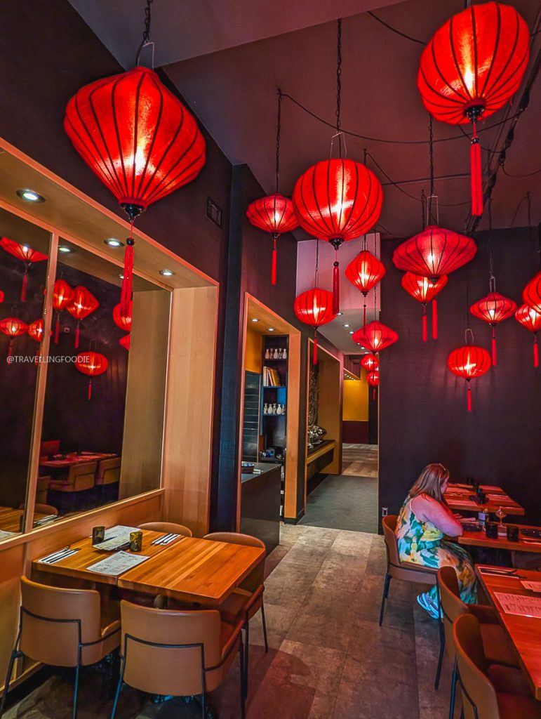 Intimate dining room illuminated by red lanterns at SULU Restaurant, a beautiful local place to eat in Saskatoon.