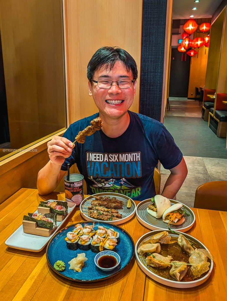 Travelling Foodie Raymond Cua eating grilled skewers and Asian tapas at SULU, uncovering top local restaurants in Saskatoon.