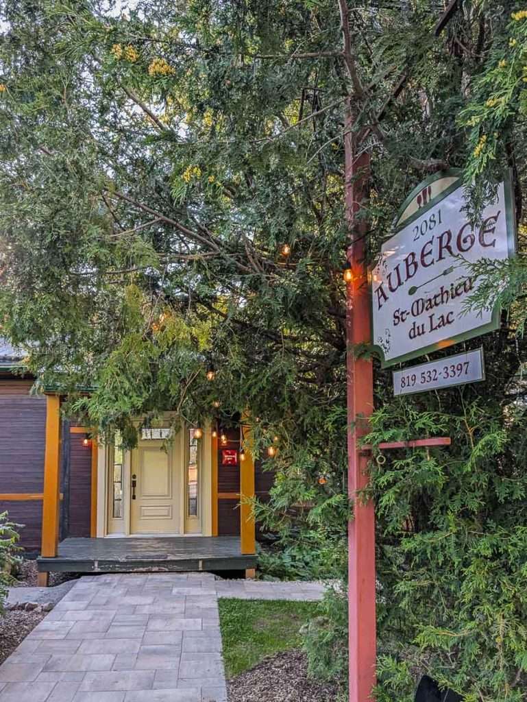 A cozy stone pathway leading to the entrance of Auberge Saint-Mathieu restaurant in Lanaudiere-Mauricie