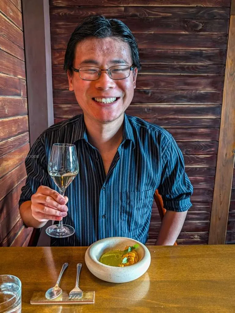 Travelling Foodie enjoying the Jardiniere course with a white wine pairing at a Lanaudiere-Mauricie luxury restaurant