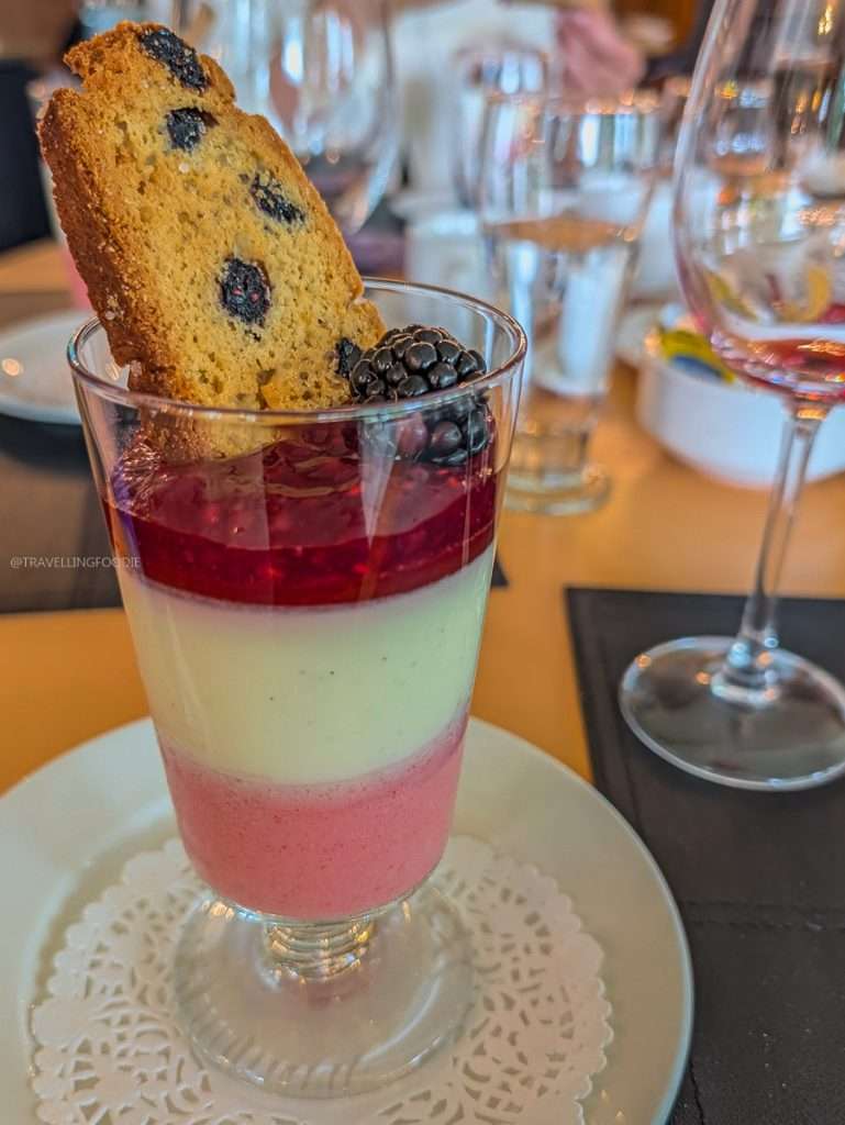 A colorful layered berry trifle dessert served in a glass at Auberge du Lac-a-l'Eau-Claire in Authentic Quebec