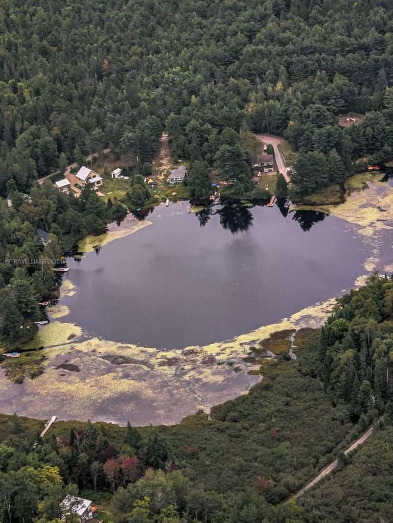 Beautiful aerial view of a forest lake during our fly and dine tour in Authentic Quebec.