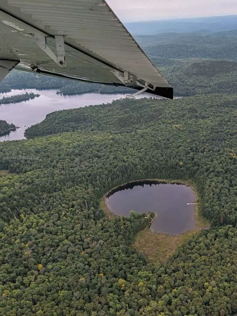 Spotting a stunning heart lake from our seaplane window during a Mauricie aviation tour