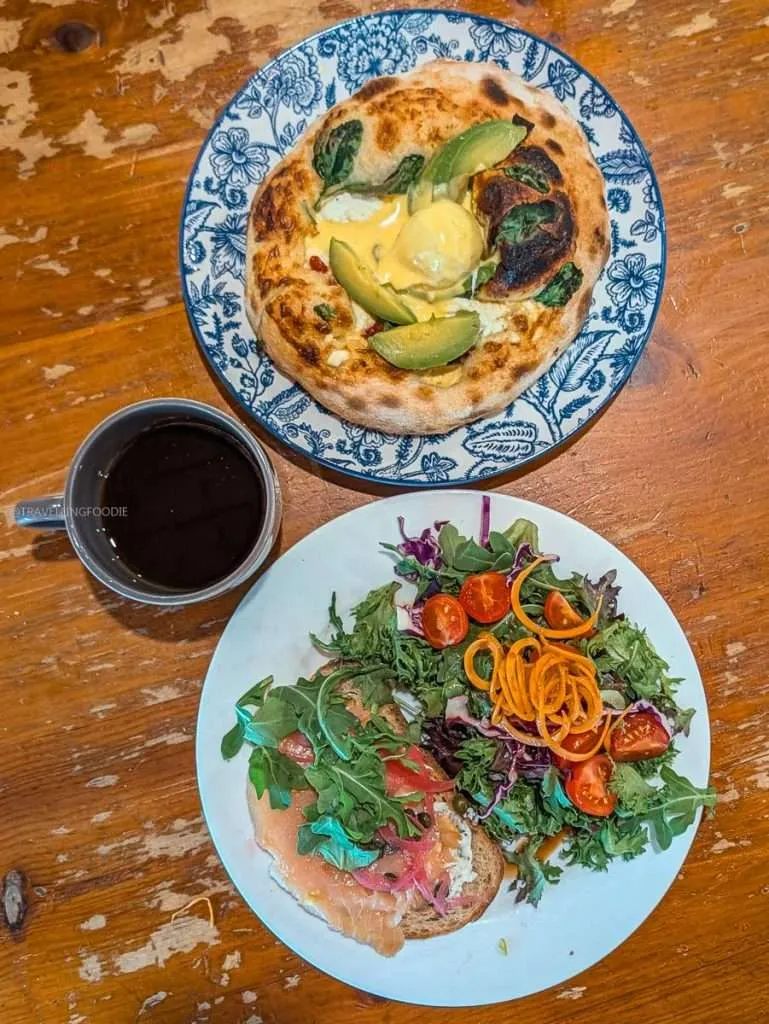 A delicious breakfast of Benny Pizza, smoked salmon toast, and coffee served at Biscotti & Cie in Chelsea, Quebec.