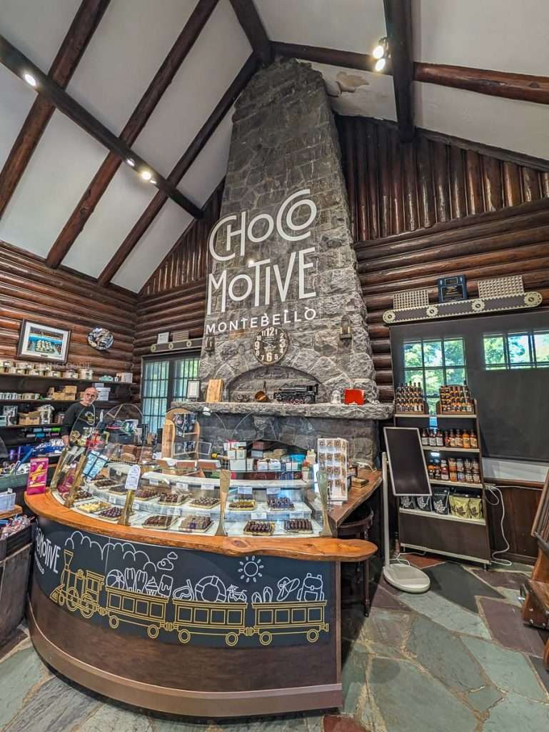 The rustic chocolate counter and stone fireplace inside ChocoMotive, an artisanal economuseum in Montebello.