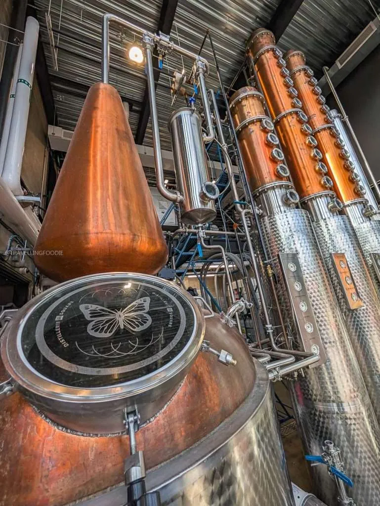 Shiny copper and stainless steel hybrid distillation stills used to make craft spirits at Distillerie du Square in Chelsea.