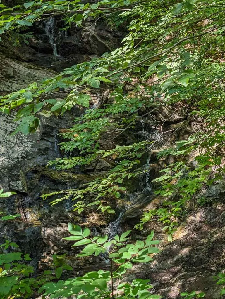 The rocky Bridal Veil Falls surrounded by forest foliage at the historic Mackenzie King Estate in Chelsea, Quebec.