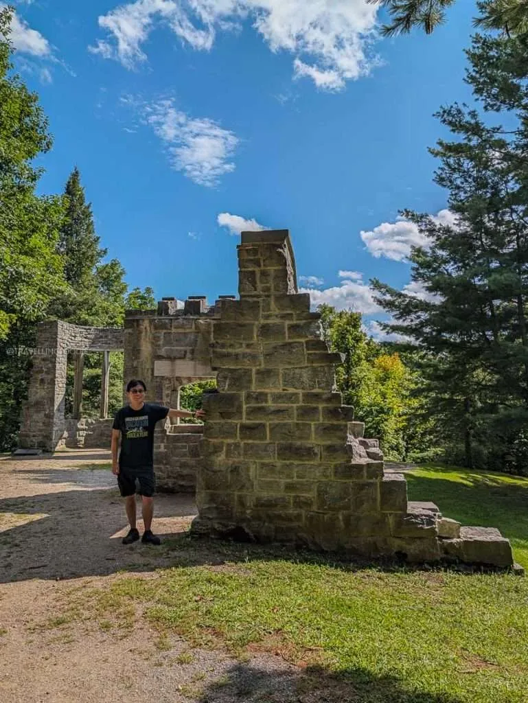 Travelling Foodie Raymond Cua exploring the romantic Abbey Ruins at the Mackenzie King Estate, a must-visit Chelsea attraction.