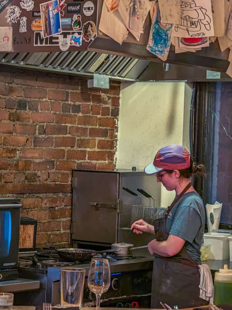 Watching the chef cook in the open kitchen at Épi, buvette de quartier during my luxury Trois-Rivieres foodie getaway