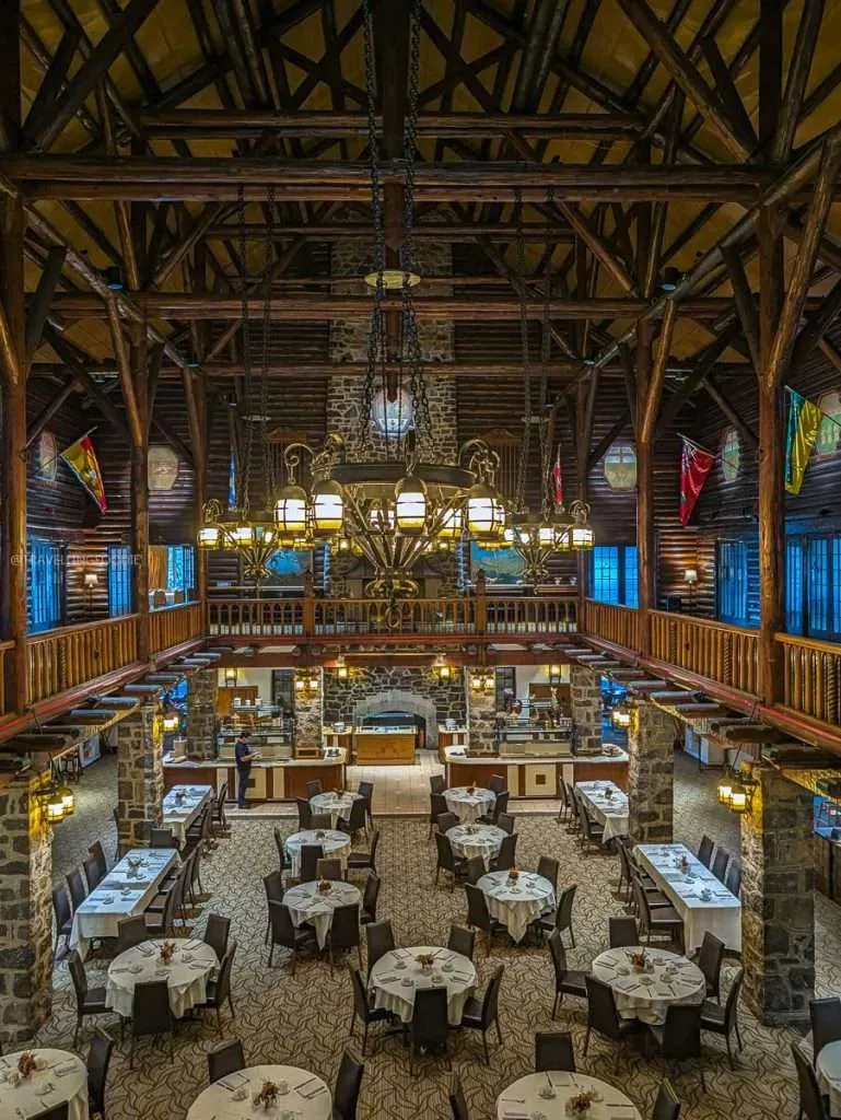The grand rustic dining room with high wooden ceilings at Aux Chantignoles in Montebello.