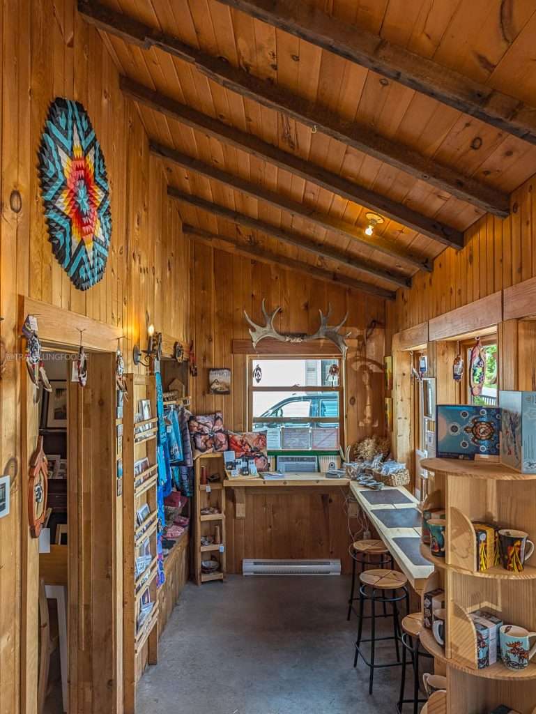 Cozy rustic wooden interior and Indigenous art inside Kisisam Patisserie in Saint-Andre-Avellin.