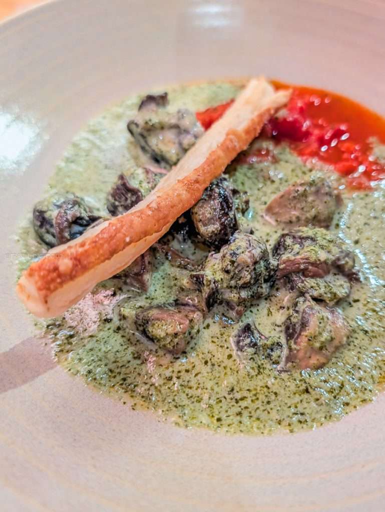 Creamy escargots with mushrooms and tomato coulis served at L'Oree du Bois, a top Chelsea Quebec restaurant.