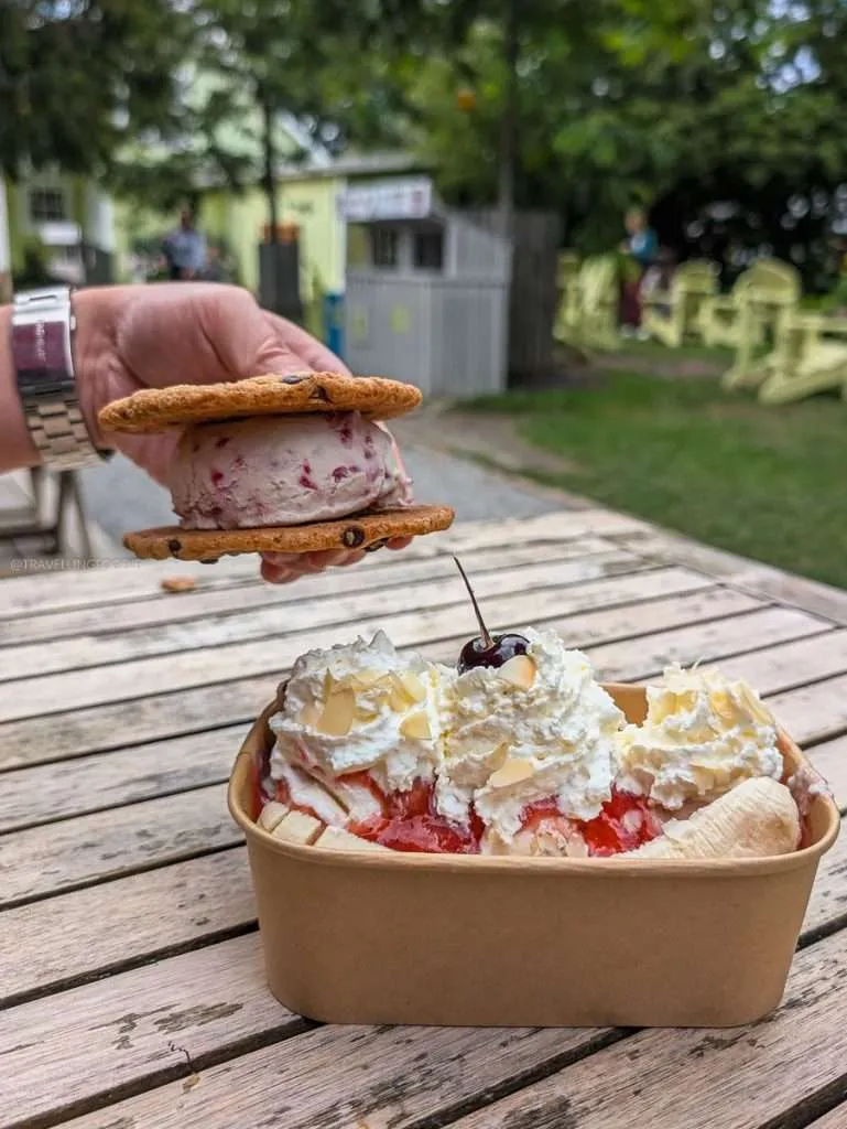 A delicious banana split and a chocolate chip ice cream sandwich on a wooden table at La Cigale in Chelsea Quebec.
