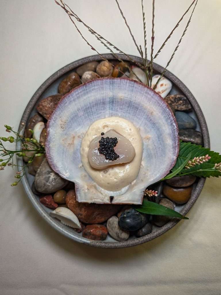 Smoked scallop with caviar served on a shell for the boreal tasting menu at Le Baluchon in Authentic Quebec