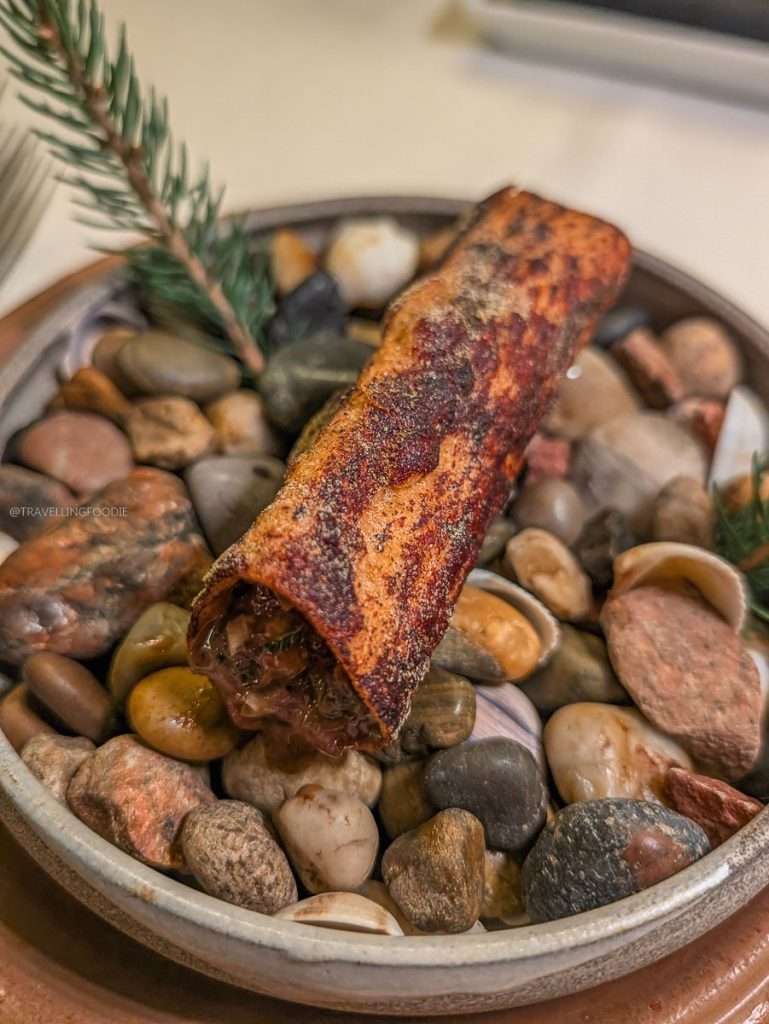 A stunning deer tartare shaped like a forest log at Le Baluchon eco-resort during my Authentic Quebec road trip