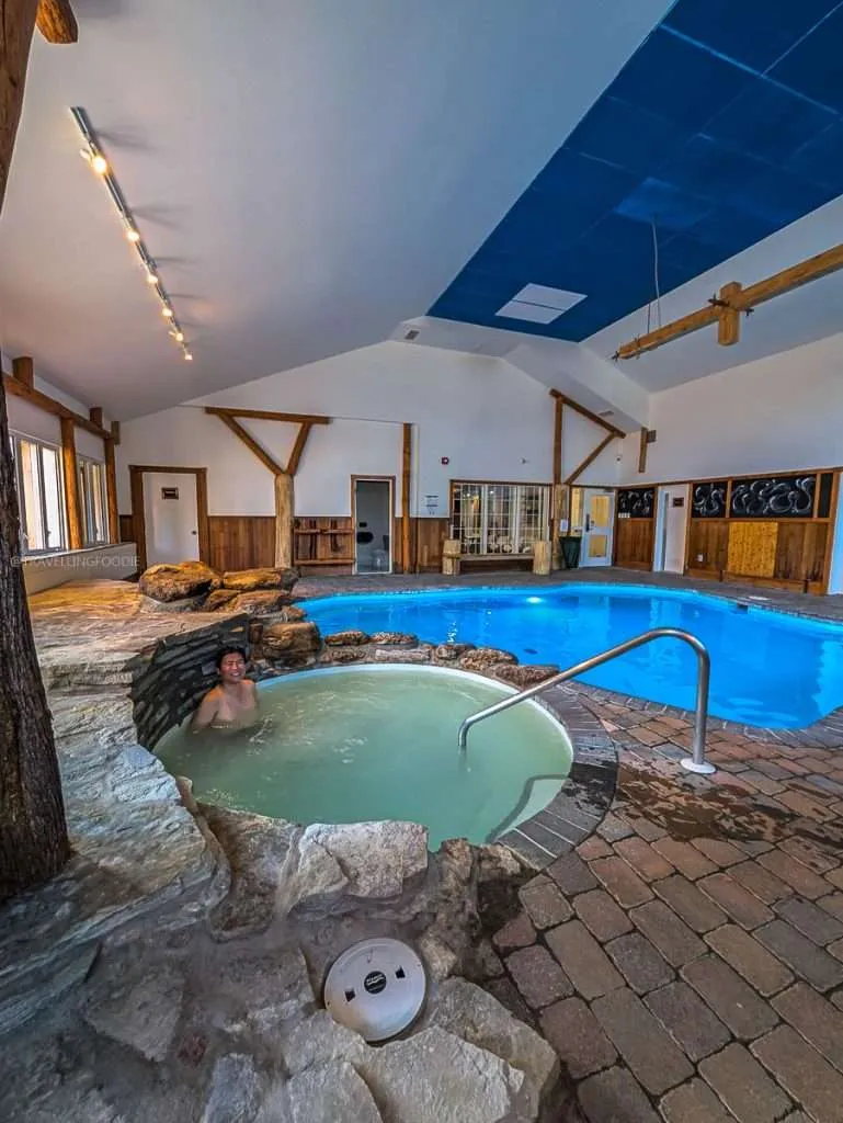 Raymond Cua relaxing in the warm indoor jacuzzi at the Le Baluchon Nordik spa during my luxury Quebec getaway