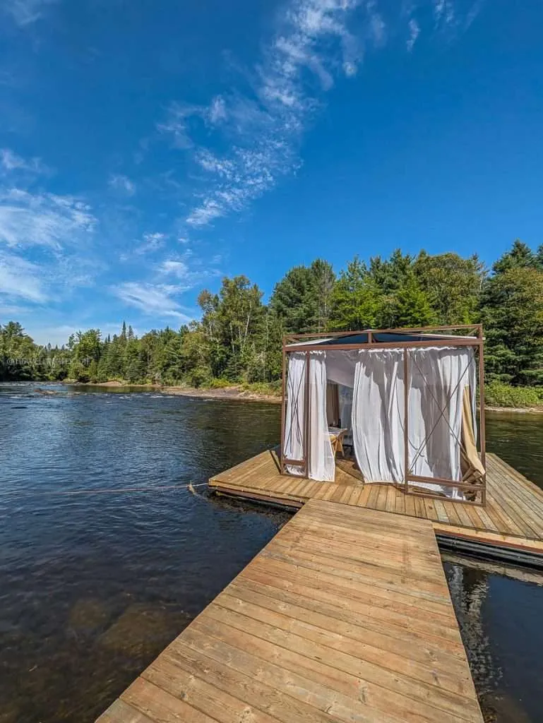 A peaceful outdoor massage cabana floating on the river at Le Baluchon during my Authentic Quebec trip