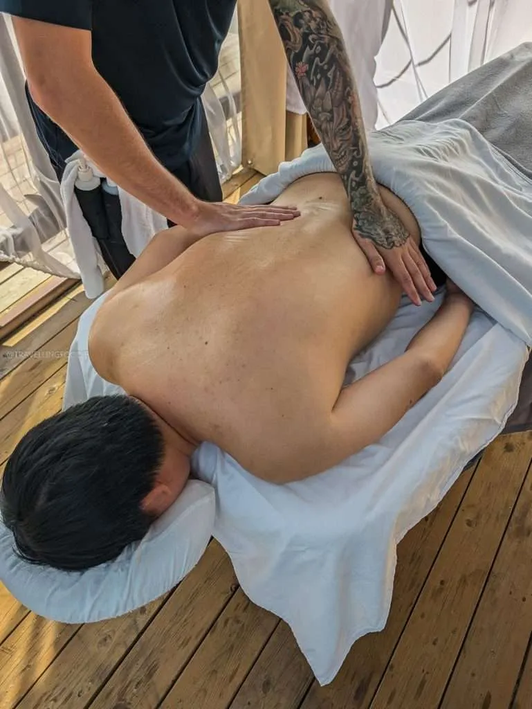 Raymond Cua enjoying a relaxing outdoor back massage at Le Baluchon eco-resort during my Authentic Quebec getaway
