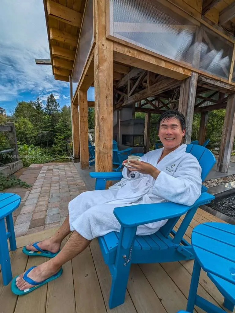 Travelling Foodie Raymond Cua enjoying tea in a cozy robe at the Nordik spa rest area at Le Baluchon in Authentic Quebec