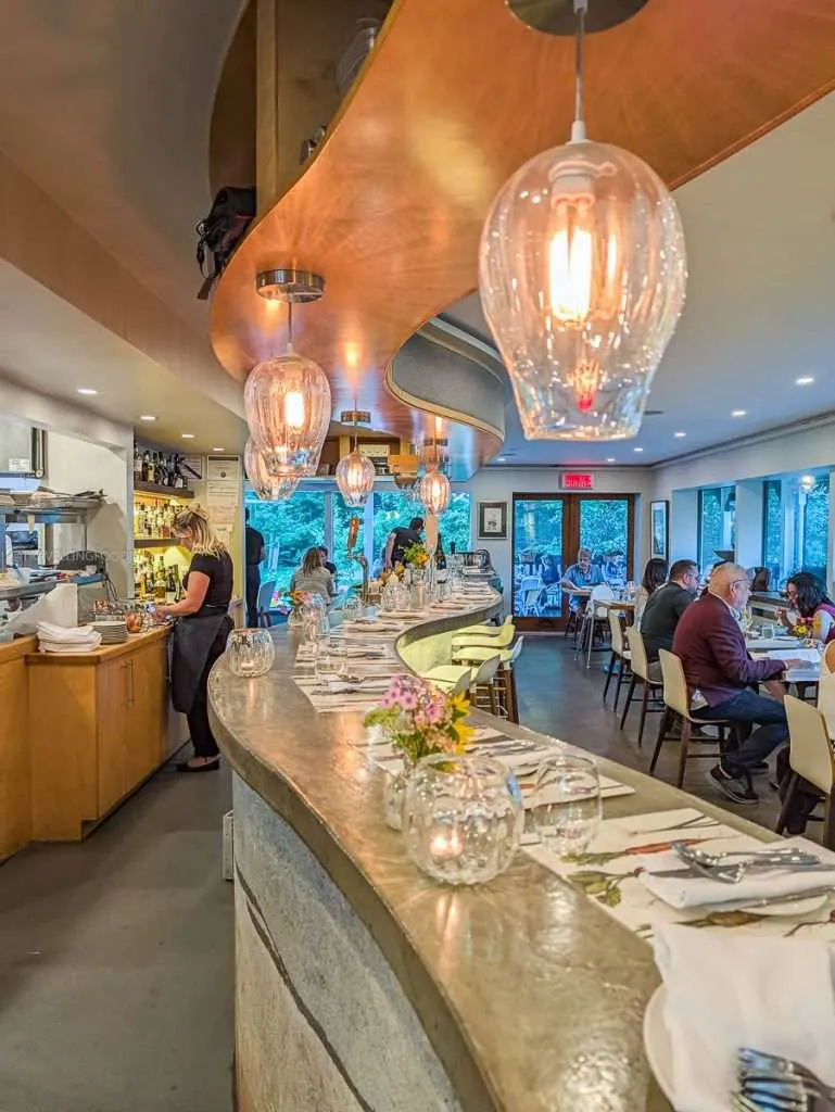 The beautiful wavy bar seating overlooking the open kitchen inside Les Fougeres, a top restaurant in Chelsea Quebec.