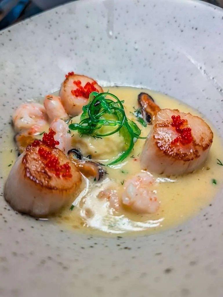 The signature Mouth of the St-Lawrence seafood dish with seared scallops and shrimp at Les Fougeres in Chelsea Quebec.