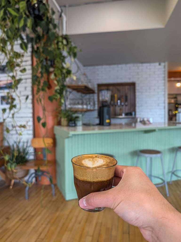 A fresh cortado coffee inside the cozy Orelys Cafe during my Trois-Rivieres road trip stop