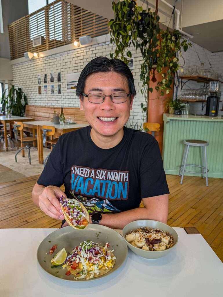 Travelling Foodie Raymond Cua eating delicious breakfast tacos and a chia bowl at Orelys Cafe in Trois-Rivieres Quebec.