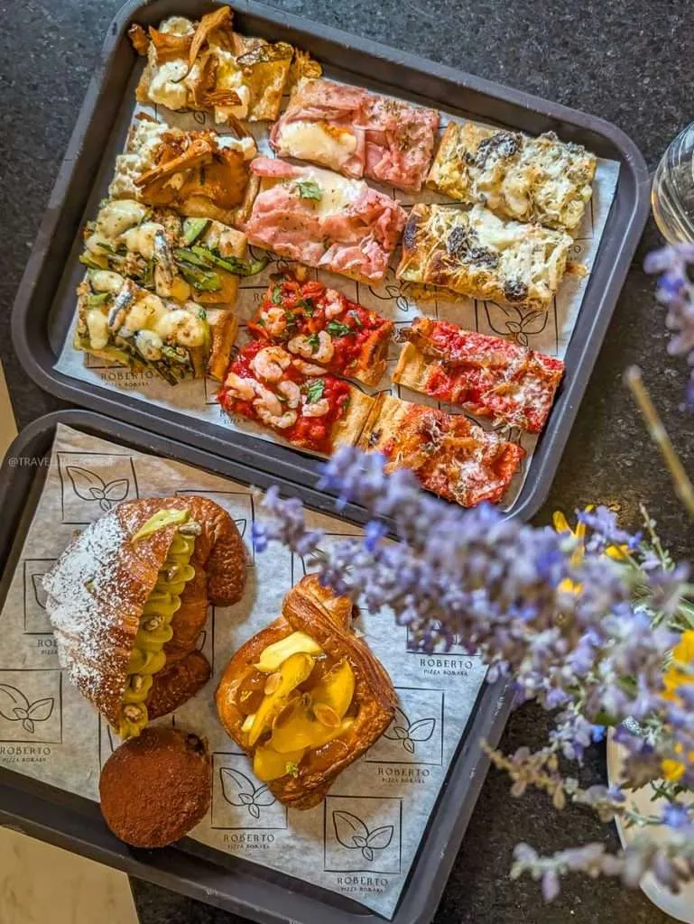 Trays of assorted Roman pizza al taglio slices and Italian pastries at Roberto Pizza Romana in Chelsea Quebec