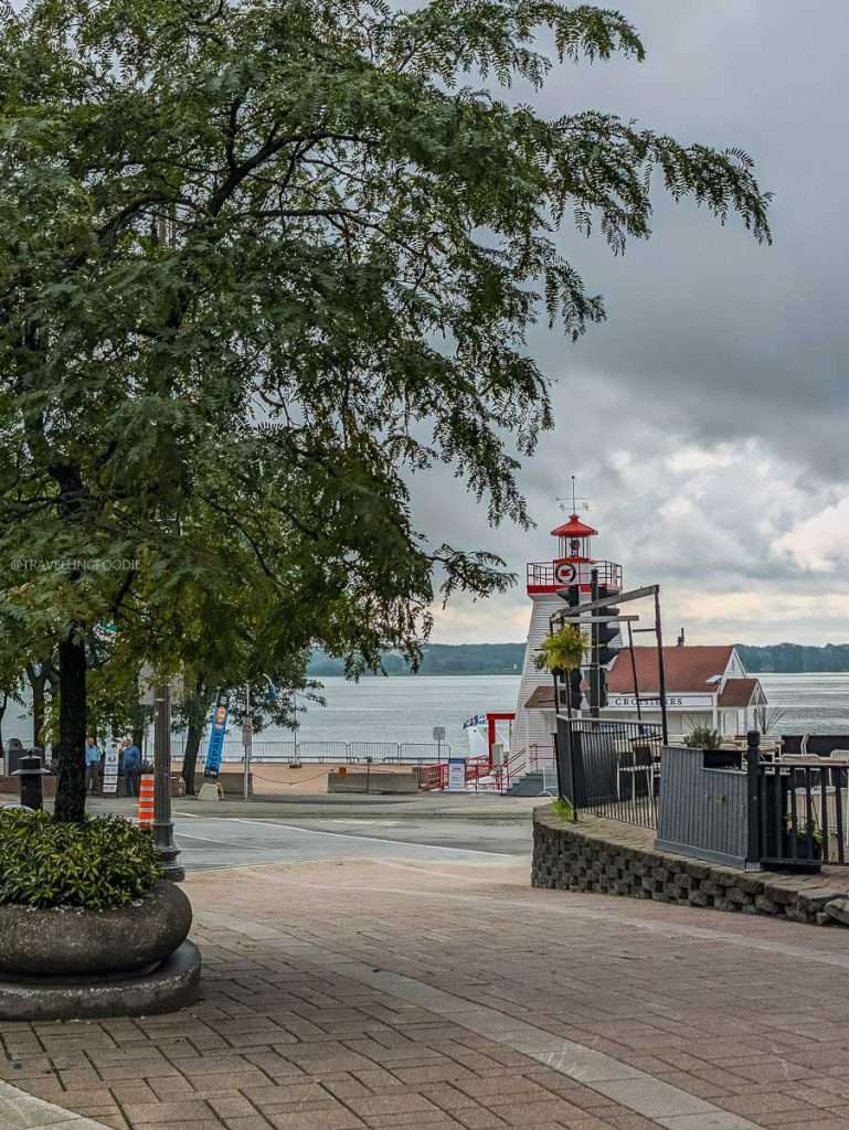 A scenic view of the St. Lawrence River and a lighthouse in historic Trois-Rivieres on my Quebec road trip.